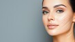 © Nataliia_Trushchenko - A woman with a very clean and smooth face. She is smiling and looking at the camera. The background is a grayish color