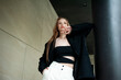 © alipko - young beautiful woman posing on the street formal modern clothes. beautiful fashionable girl posing in the street