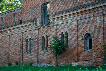 The windows of a ruined brick stable. 19th century buildings