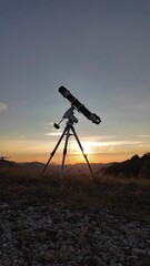 Wall Mural - Preparing for night sky observing with a astronomical telescope just before sunset.	

