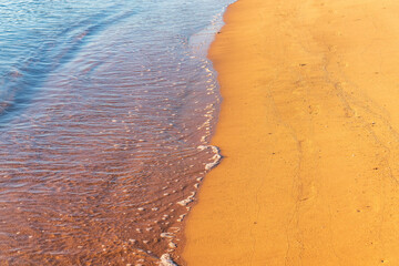 Soft wave of the sea on the sandy beach.