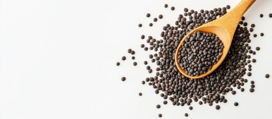 Aufkleber - Black lentil beans with a wooden spoon on a white background. with copy space image. Place for adding text or design