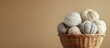 © vxnaghiyev - Beige woolen yarn skeins for knitting tumbled out of the handcrafted brown basket Materials for knitting crafts and hobbies. with copy space image. Place for adding text or design