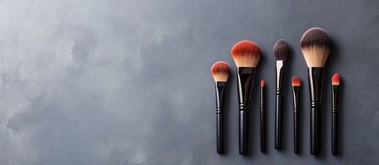 Aufkleber - Makeup brushes and cosmetics set against a grey background copy space
