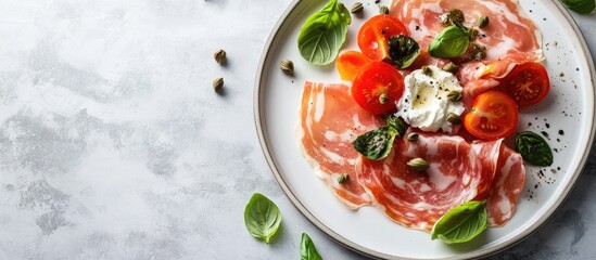 Poster - Slices of Prosciutto coppa di Parma ham served with ricotta cheese tomato capers and basil on a light plate top view copyspace