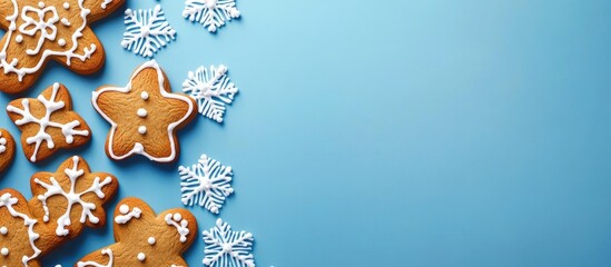 Poster - Christmas gingerbread cookies on a blue backdrop Christmas setting Festive scene. with copy space image. Place for adding text or design