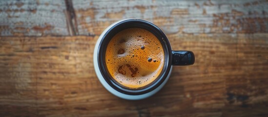 A top view of a cup of espresso on a background of coffee beans with a shallow depth of field. with copy space image. Place for adding text or design