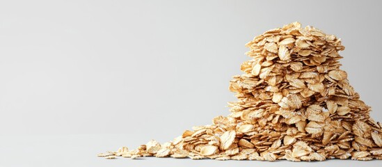 Fototapete - Stack of dry oat flakes with copy space clipping path