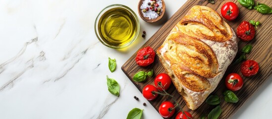 Canvas Print - Freshly baked ciabatta bread with cherry tomatoes olive oil basil and salt on a walnut wood board against a white background top view copy space