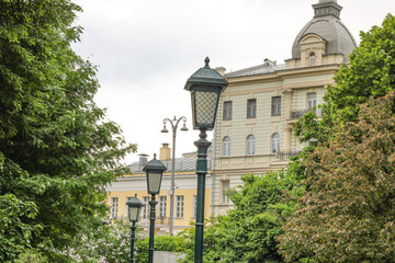 A street light stands in front of a building with a dome