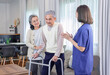 © Verin - old asian man patient trying to walk by using walker,being assist by a nurse caregiver and a senior wife standing and supporting beside him,concept of elderly health care,homecare,home health nursing
