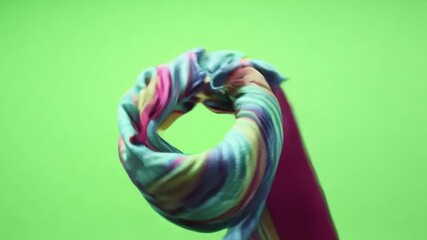 Poster - A colorful scarf spinning against a green screen background, symbolizing vibrancy and style.