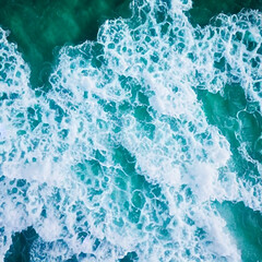 Aerial view beautiful of sea waves from drone. Stock image of blue color of ocean water, sea surface. Top view on turquoise waves, clear water surface texture.