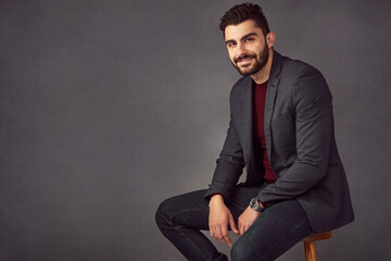 Poster - Business, man and portrait in studio on chair with confidence for legal career and advisor at law firm. Professional, lawyer and employee with smile on mockup space at workplace on gray background
