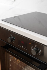 Wall Mural - Black electric oven with timer display in kitchen