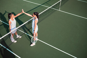 Wall Mural - Court, tennis and women with high five for sports, competition and game challenge with thank you. Outdoor, athletes or people with hands celebration after match, training and well done for tournament