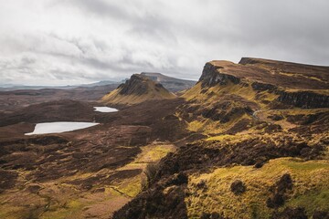 Wall Mural - the Quiraing landslip on the Isle of Skye, Scotland with dramatic clouds and rugged landscape