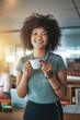 © SunriseDon/peopleimages.com - Happy woman, portrait and afro with coffee at office for night business, caffeine or drink. Young female person or creative employee with smile for espresso beverage, cappuccino or tea in startup
