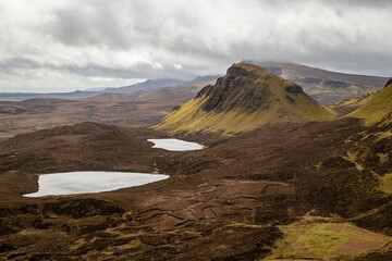 Sticker - Stunning landscape of the Quiraing on the Isle of Skye with dramatic clouds and a serene lake