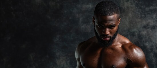 Poster - An appealing Afro American man is posing in a studio against an isolated background. with copy space image. Place for adding text or design
