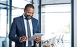 © peopleimages.com - Black man, happy and tablet for reading business email, communication and networking in office. African financial advisor, smile and tech for online news, positive feedback and investment research
