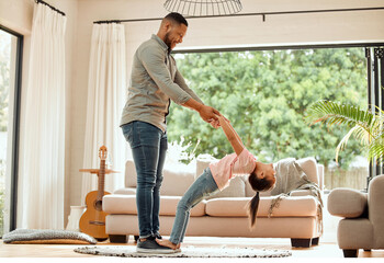 Canvas Print - Play, father and child in dancing, support and bonding as family, together and embrace in home. Man, daughter and affection for love, connection and happy with trust, comfort and joy in living room