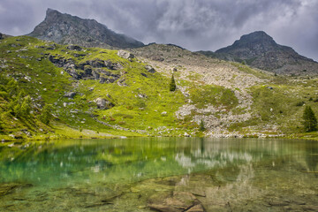 Wall Mural - view of a small lake high in the mont avic nature park in the Graian Alps in the aosta valley