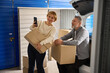© Svitlana - Male and woman in self storage unit standing near auto