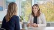 © bird_saranyoo - A Female real estate agent in her youth Sitting at the table with a female customer Talk to each other and smile during the conversation.