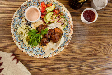 Wall Mural - Grilled Shashlik with Fresh Vegetables and Onions on Decorative Plate