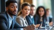© AS Studio - diverse group of business professionals seated at a panel discussion table, presenting and engaging in discussion, modern conference room setting