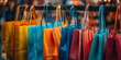© AMA STUDIO - Colorful shopping bags hanging on clothes rack representing retail sales and consumerism