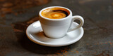 Single shot of espresso in a white demitasse cup on a matching saucer