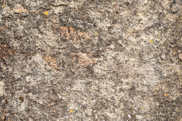 A close up of a rough textured stone surface