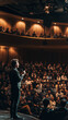 © Nelson - Inspirational Speaker Engages Captivated Audience in Grand Auditorium