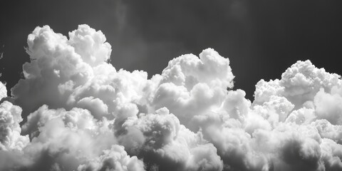 Poster - A black and white photograph of clouds in the clear blue sky