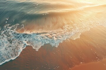 Poster - Aerial view of a beach with waves crashing ashore, ideal for coastal-themed projects