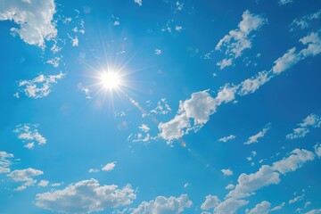 Poster - A bright sun shines through white clouds in a clear blue sky, great for weather or nature themed images