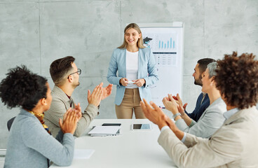 Wall Mural - young business people meeting office businesswoman portrait happy smiling applause congratulating teamwork grouphappy smiling success applauding woman