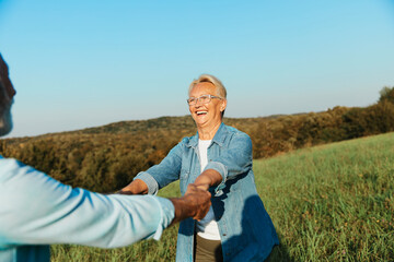 Wall Mural - woman man outdoor senior couple happy lifestyle retirement together smiling love dancing nature mature