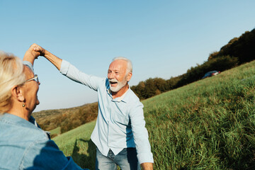 Wall Mural - woman man outdoor senior couple happy lifestyle retirement together smiling love dancing nature matu