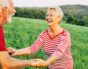 Wall Mural - woman man outdoor senior couple happy lifestyle retirement together smiling love dancing fun playing