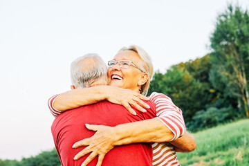 Wall Mural - woman man outdoor senior couple happy lifestyle retirement together smiling love hug nature mature
