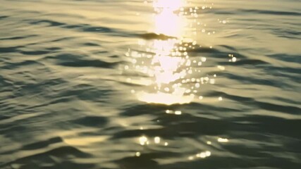 Poster - The sunlight glimmers off the surface of the water illuminating the delicate patterns created by the winds gentle touch.