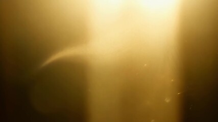 Aufkleber - In a dimly lit room the sunlight filters through a thin layer of dust revealing a delicate shimmering layer of airborne particles that appear almost weightless and delicate.