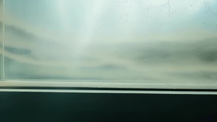 Aufkleber - The camera slowly pans across a window revealing intricate patterns of dust that have accumulated in the corners and edges.