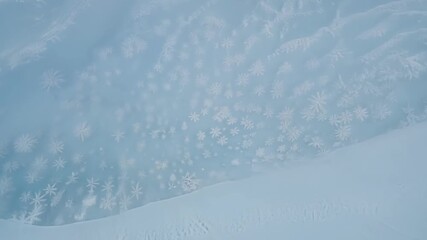 Aufkleber - Zooming in on the untouched snow the camera captures the delicate curves and ripples left by the gusts of wind creating striking snow drift patterns.
