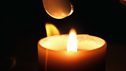 Poster - Tight shot of a candle flame being snuffed out with a candle snuffer resulting in the sudden disappearance of light and warmth.