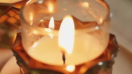 Poster - Detailed footage of a candle flame casting a warm glow on a delicate glass candle holder creating a cozy and inviting atmosphere.