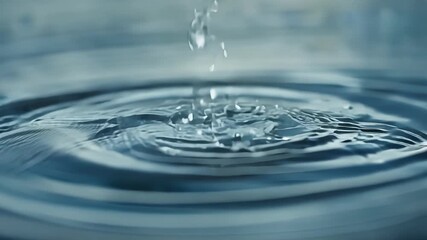 Aufkleber - Macro footage of raindrops falling onto a puddle each one causing a distinct splash and ripple that slowly fades away.
